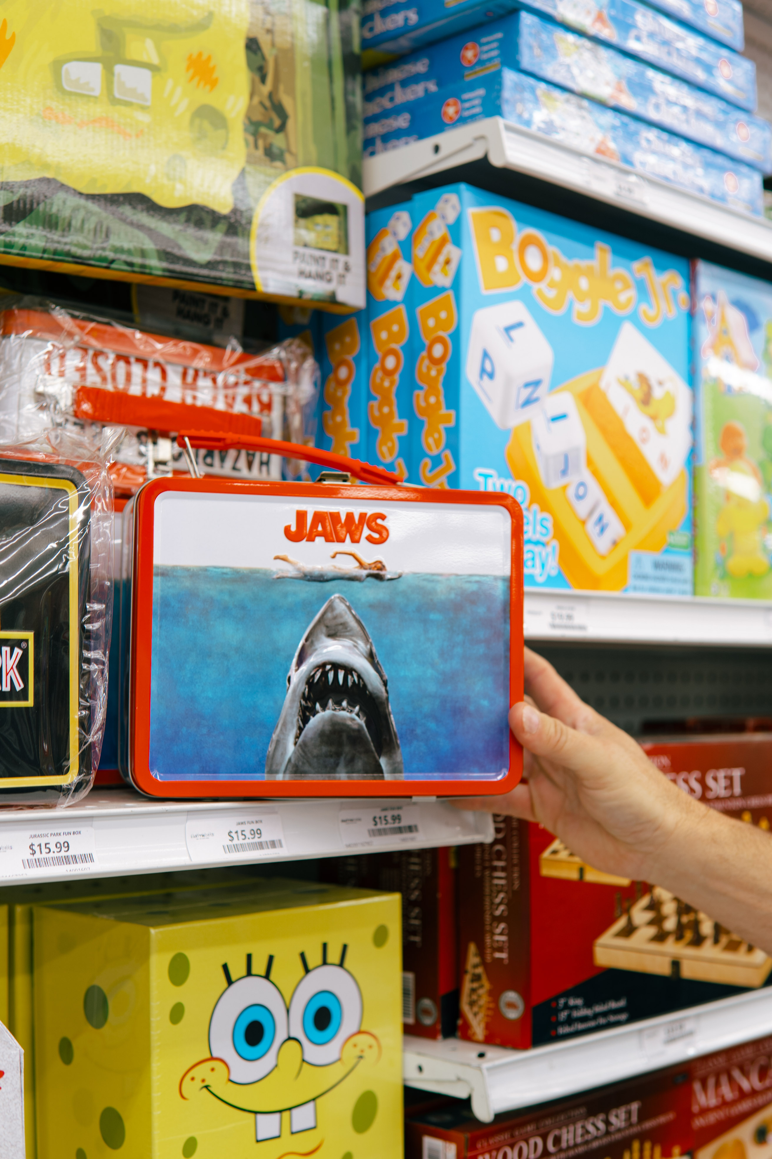 Retro Jaws lunchbox and SpongeBob board games on PartyWorks shelves